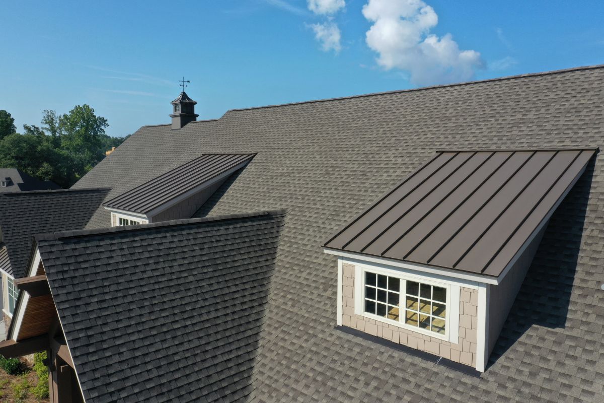 A professional roofing team working on a house in Charlotte, NC, showcasing their roofing services and expertise.